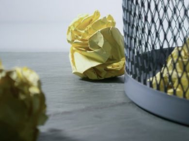 focus-photo-of-yellow-paper-near-trash-can