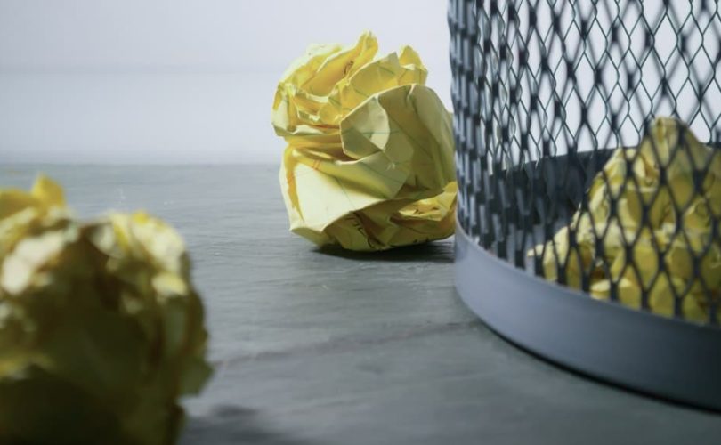 focus-photo-of-yellow-paper-near-trash-can